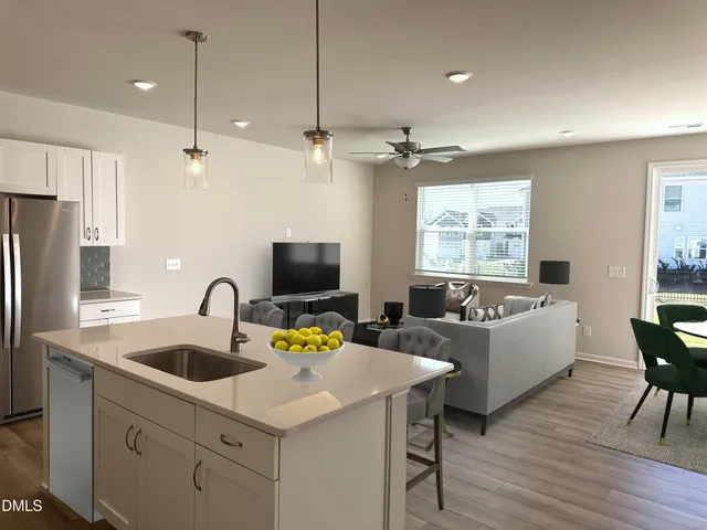 a kitchen with a table chairs refrigerator and microwave