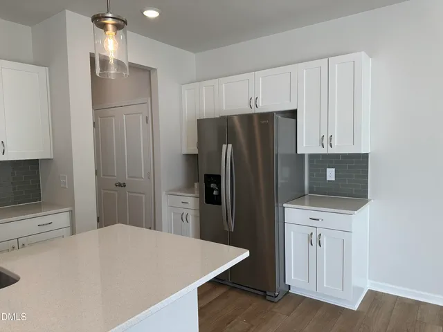 a kitchen with stainless steel appliances a refrigerator and cabinets