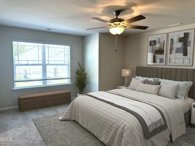 a bedroom with a large bed and a chandelier
