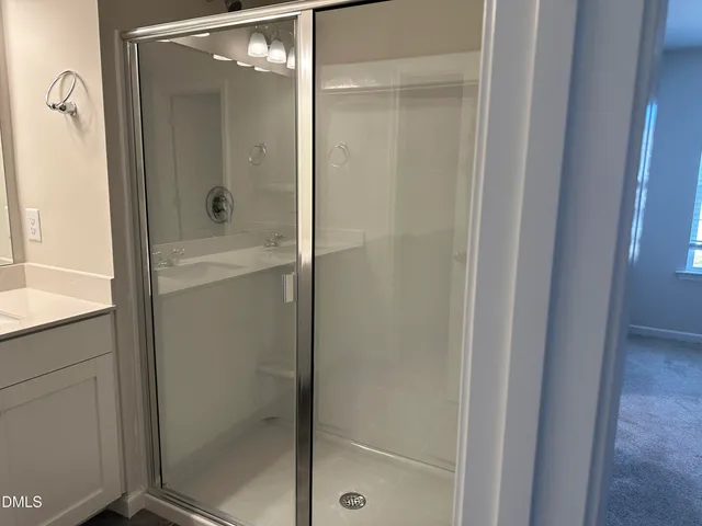 a bathroom with a glass shower door