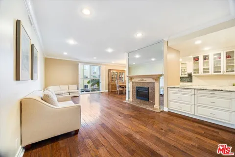 a living room with furniture wooden floor and a fireplace