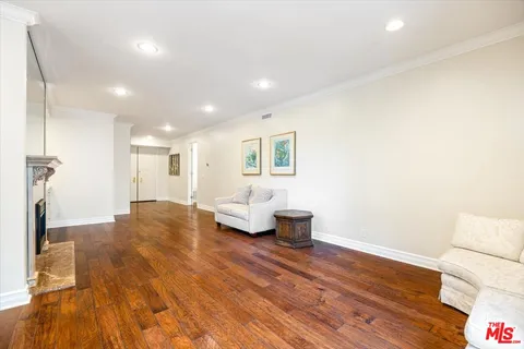 a view of a kitchen with furniture and wooden floor