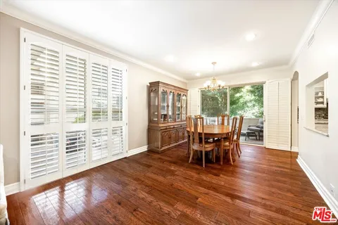 a kitchen with stainless steel appliances granite countertop a refrigerator sink and white cabinets