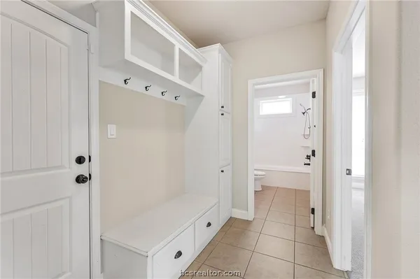 a bathroom with a shower and a glass door