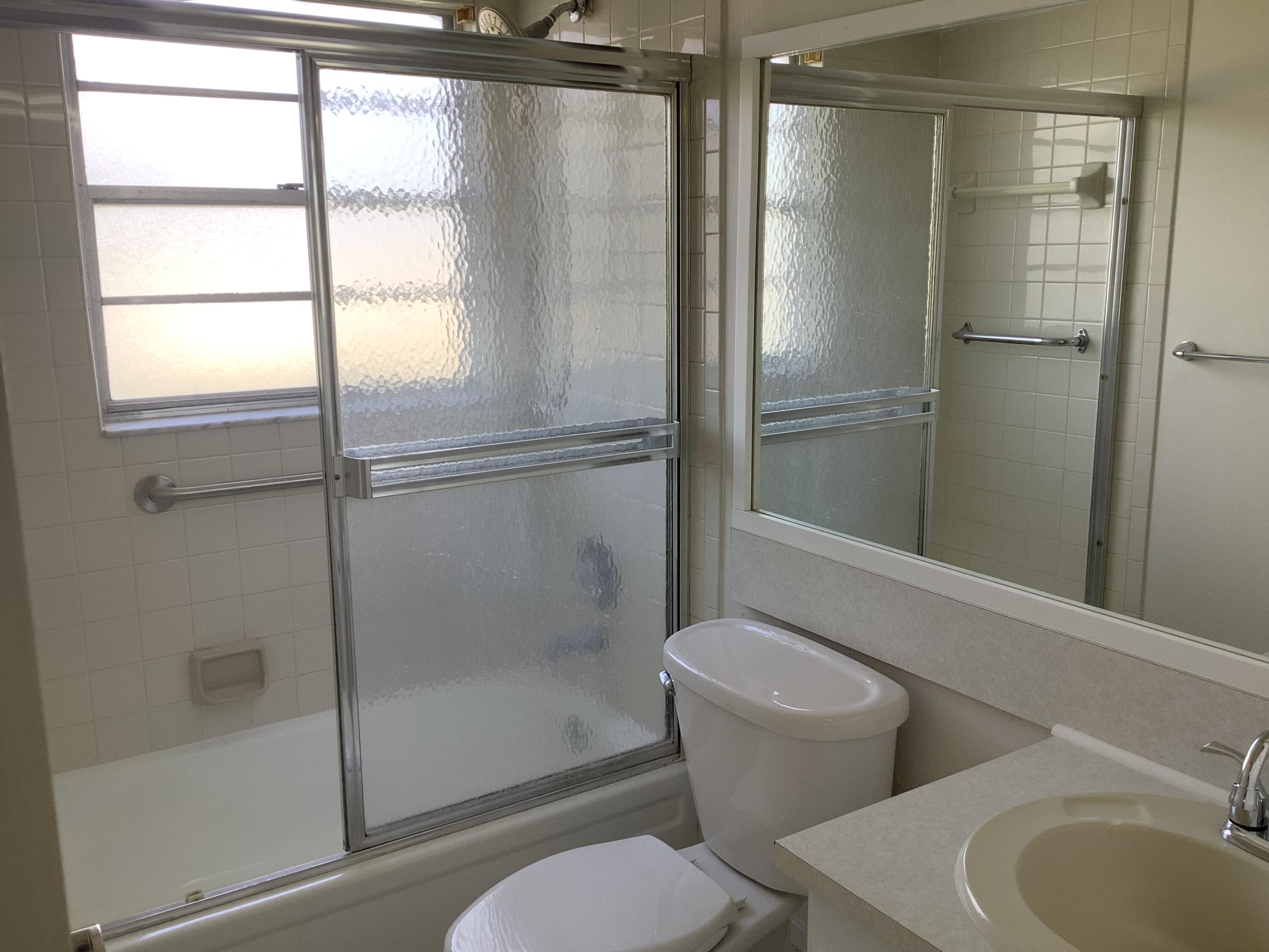 560 Fanshaw North, Unit 560 Boca Raton, FL 33434 - Photo 10 of 26 a bathroom with a toilet and a shower