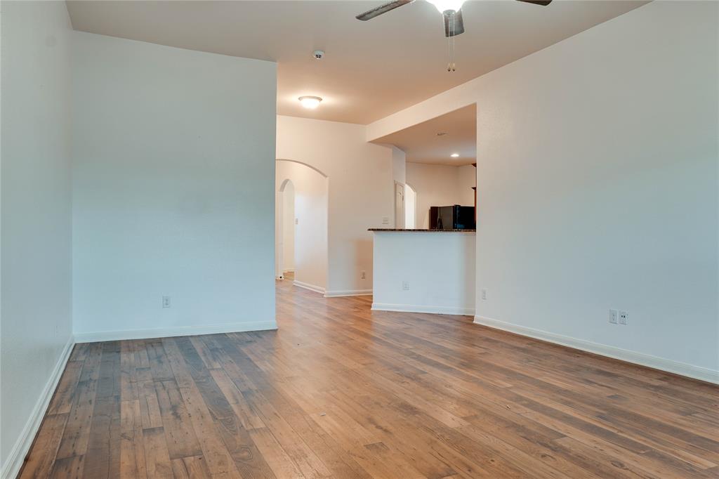 1232 Switchgrass Lane Crowley, TX 76036 - Photo 27 of 31 a view of a kitchen with wooden floor and a fireplace