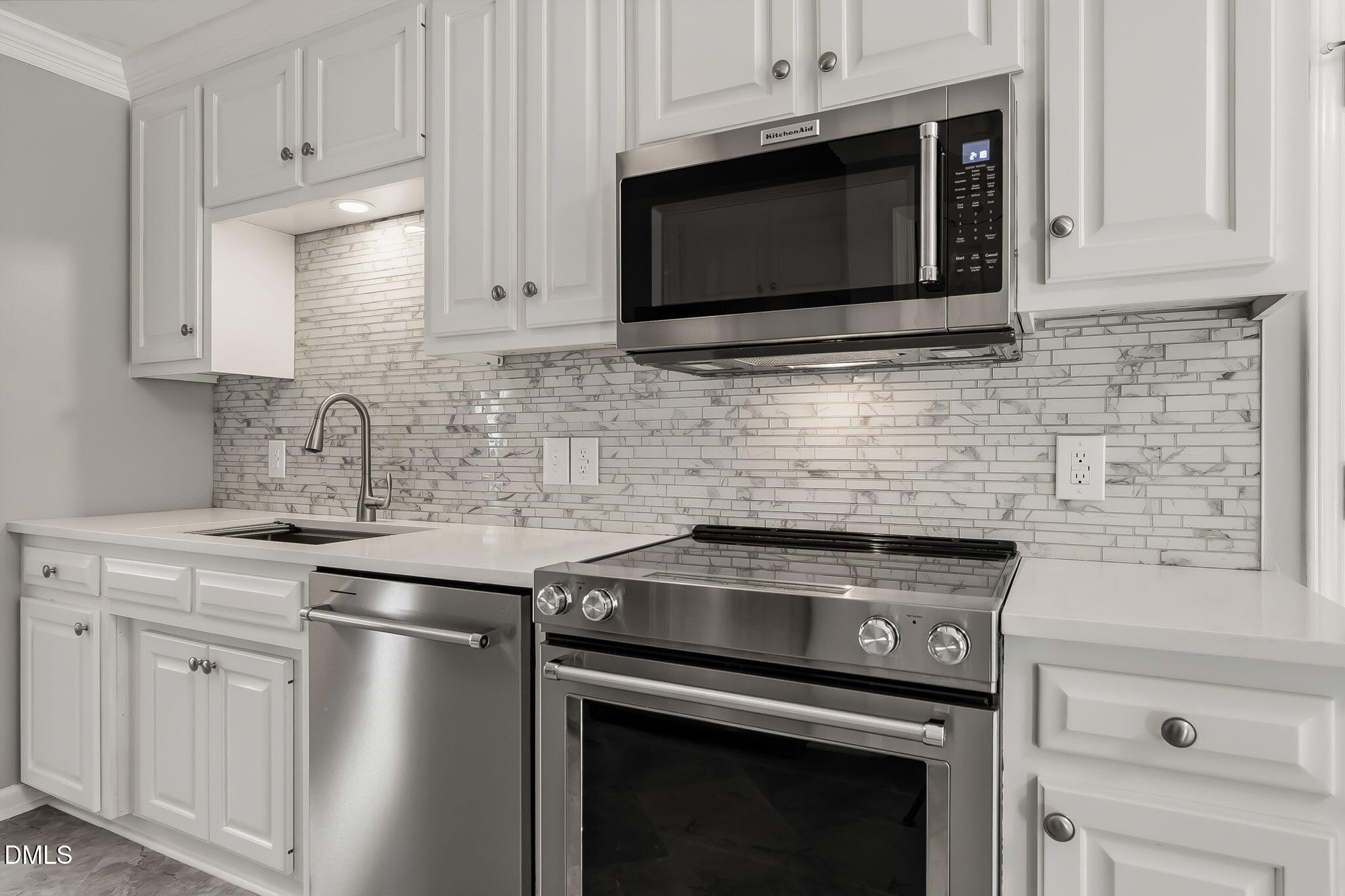 1112 Tyler Farms Drive Raleigh, NC 27603 - Photo 23 of 78 a kitchen with stainless steel appliances granite countertop white cabinets stove and microwave