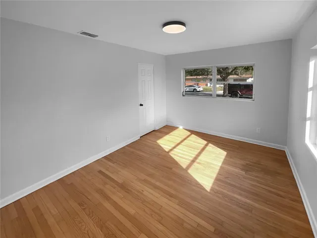 a view of a big room with wooden floor and air conditioner