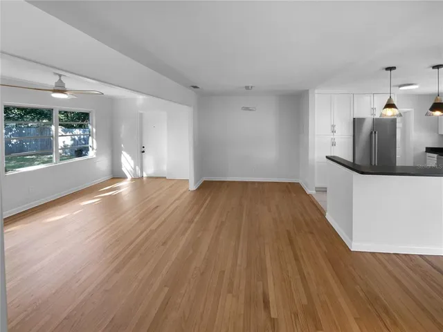 a view of a kitchen with wooden floor and a sink