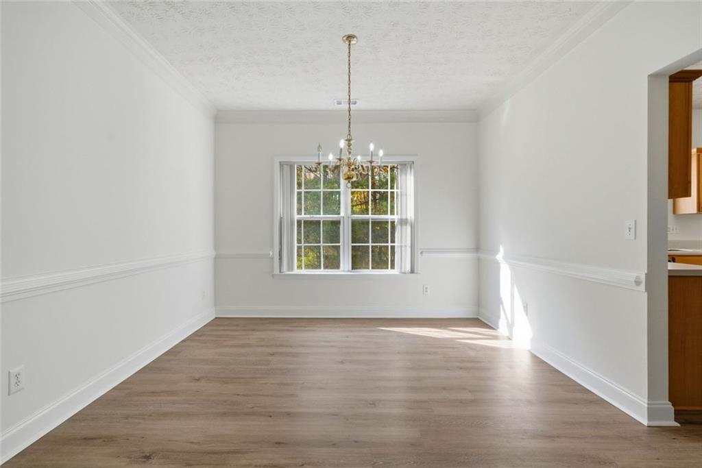 2254 Caneridge Trail Southwest Marietta, GA 30064 - Photo 11 of 30 a view of an empty room with wooden floor and a window