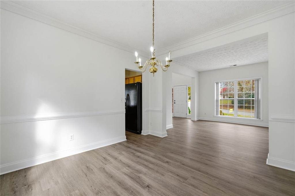 2254 Caneridge Trail Southwest Marietta, GA 30064 - Photo 12 of 30 an empty room with wooden floor and windows