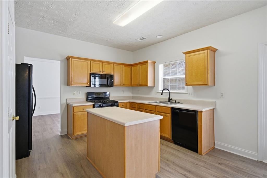 2254 Caneridge Trail Southwest Marietta, GA 30064 - Photo 14 of 30 a kitchen with stainless steel appliances granite countertop a sink stove microwave and refrigerator