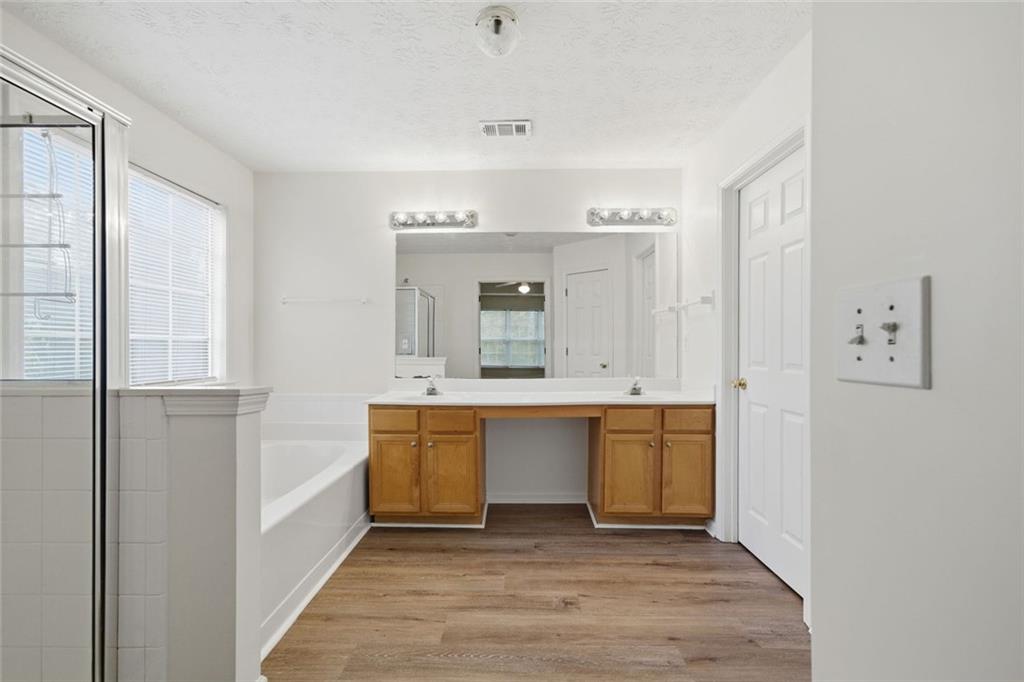 2254 Caneridge Trail Southwest Marietta, GA 30064 - Photo 18 of 30 a bathroom with a sink mirror and a bathtub