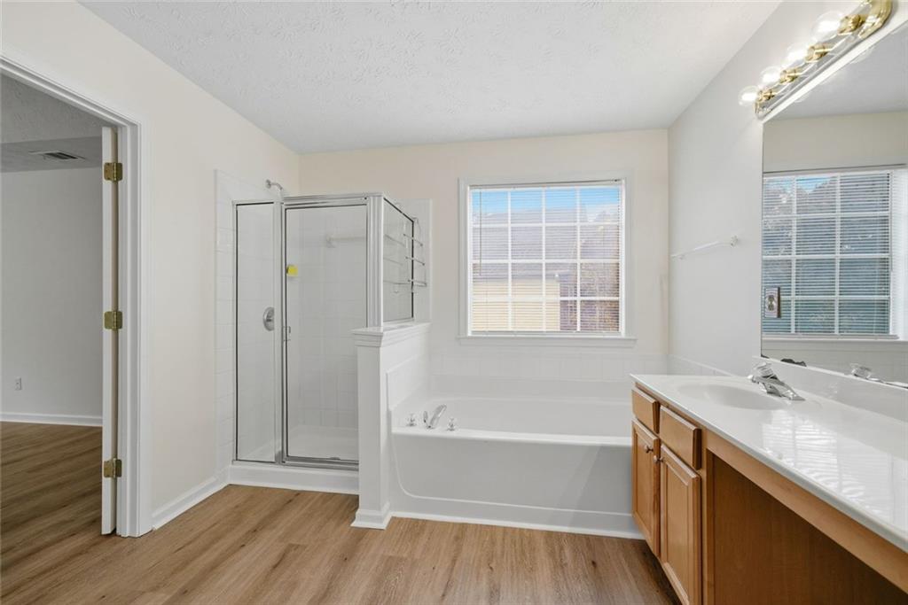 2254 Caneridge Trail Southwest Marietta, GA 30064 - Photo 19 of 30 a bathroom with a tub sink shower and a mirror