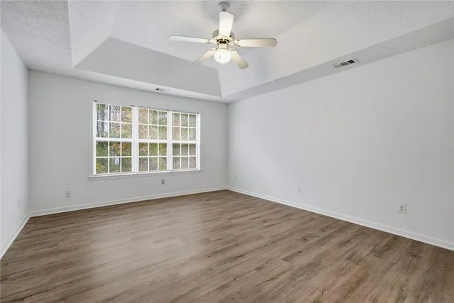 wooden floor in an empty room with a window