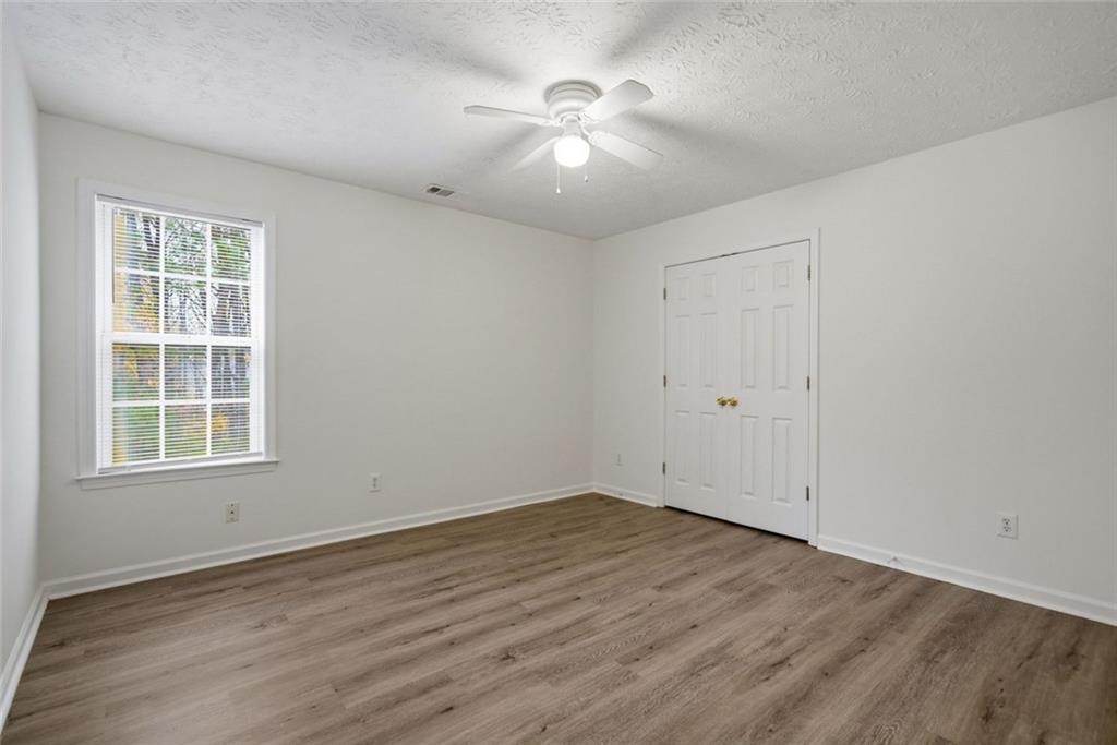 2254 Caneridge Trail Southwest Marietta, GA 30064 - Photo 22 of 30 an empty room with wooden floor and windows