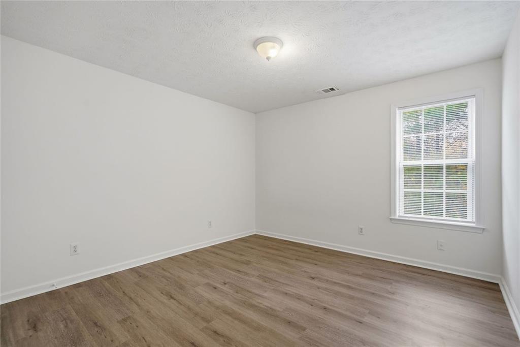 2254 Caneridge Trail Southwest Marietta, GA 30064 - Photo 23 of 30 an empty room with wooden floor and windows