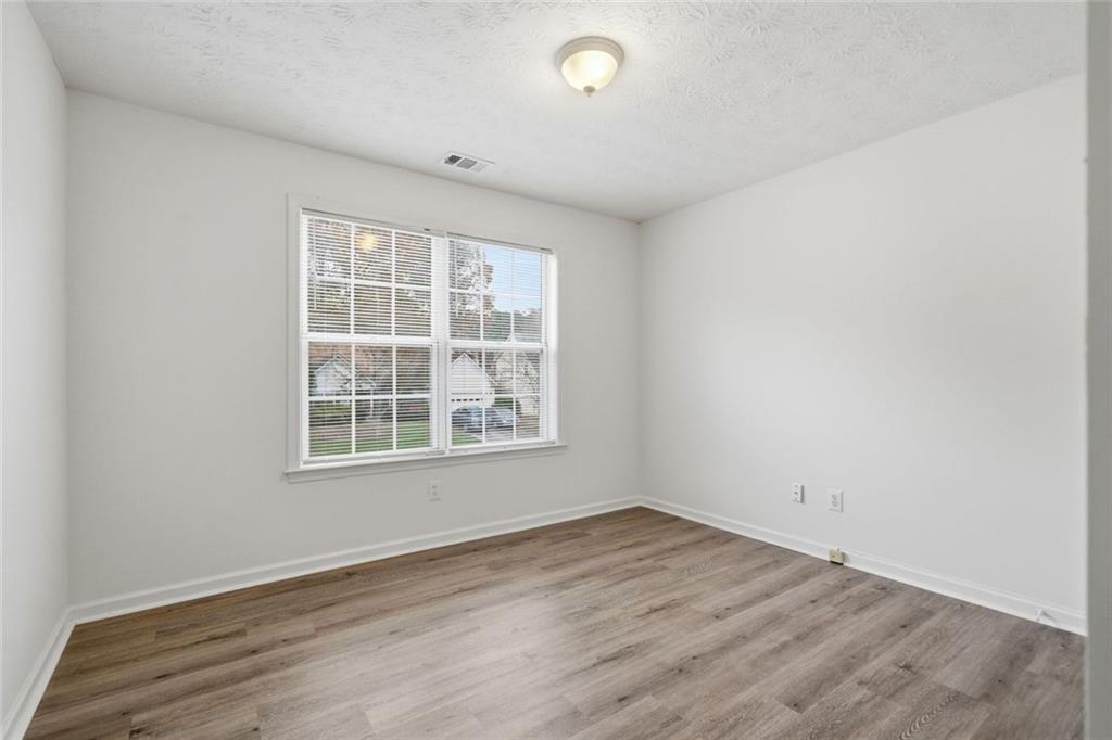 2254 Caneridge Trail Southwest Marietta, GA 30064 - Photo 24 of 30 an empty room with wooden floor and windows