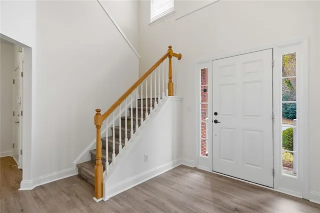 a view of an entryway with wooden floor