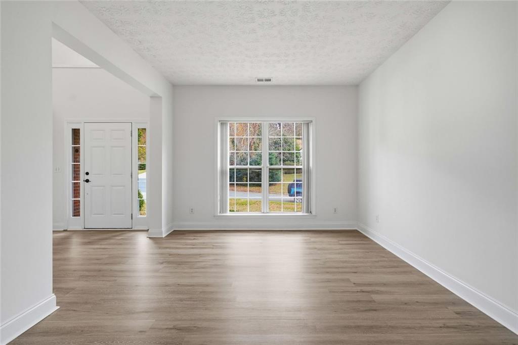 2254 Caneridge Trail Southwest Marietta, GA 30064 - Photo 7 of 30 a view of an empty room with wooden floor and a window