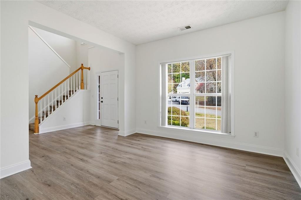 2254 Caneridge Trail Southwest Marietta, GA 30064 - Photo 8 of 30 a view of an empty room with wooden floor and a window
