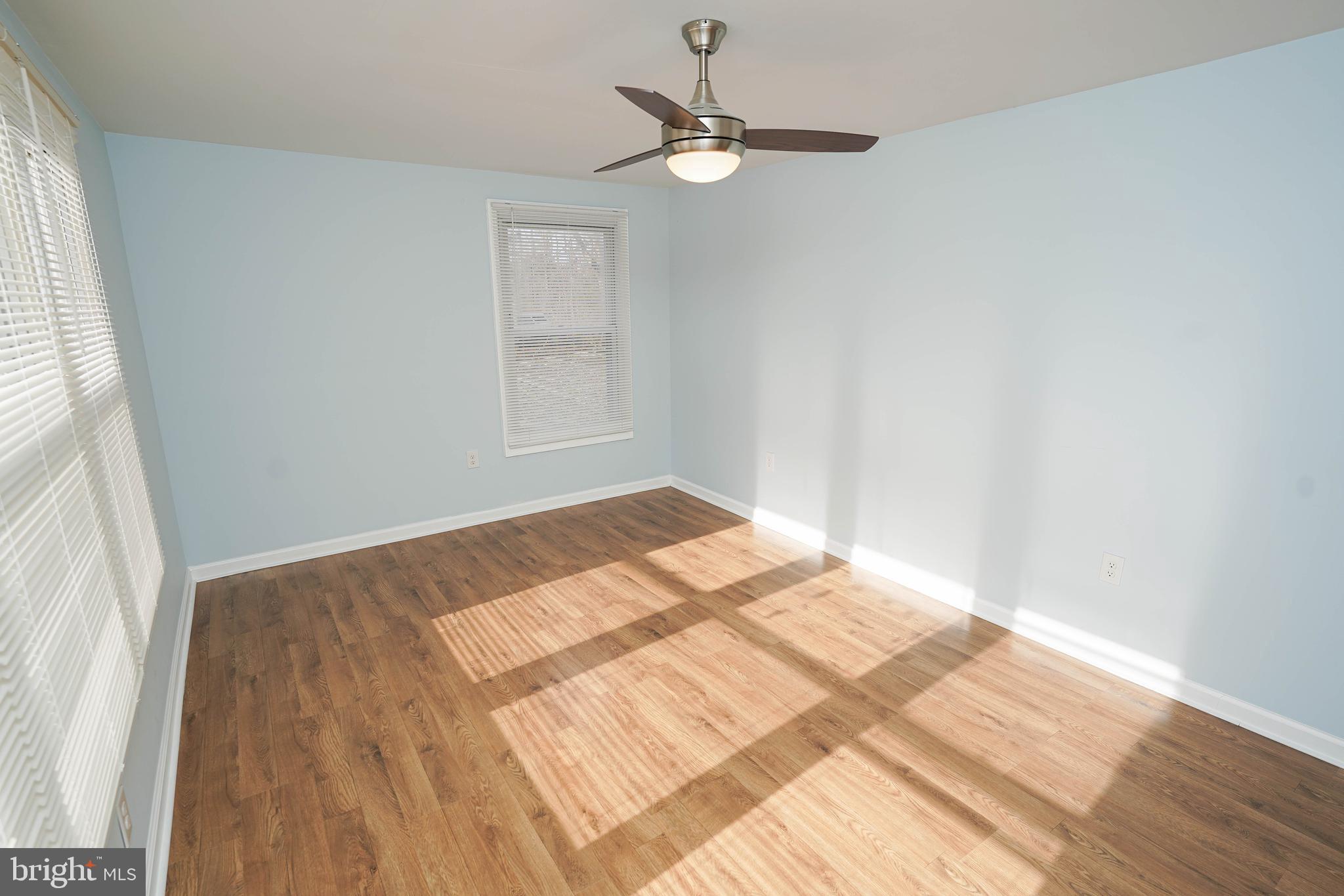 31872 Flower Hill Church Road Eden, MD 21822 - Photo 21 of 28 a view of a bedroom with wooden floor and a ceiling fan