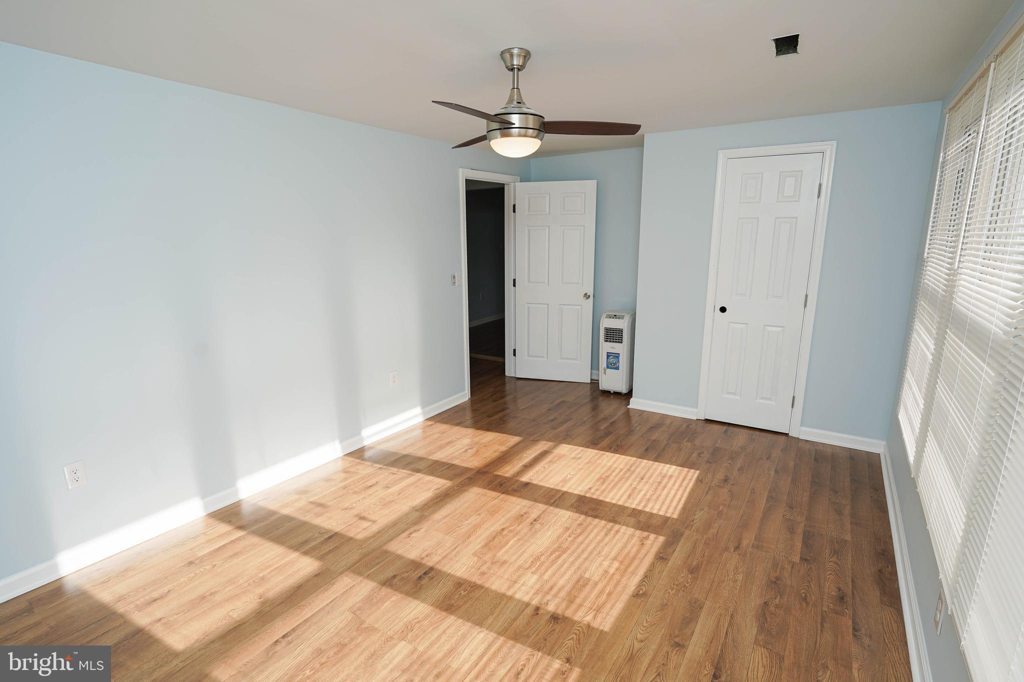 31872 Flower Hill Church Road Eden, MD 21822 - Photo 22 of 28 a bedroom with a bed and a chandelier