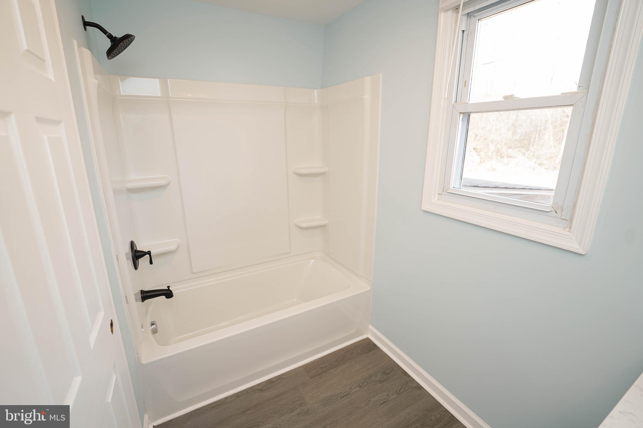 31872 Flower Hill Church Road Eden, MD 21822 - Photo 26 of 28 a bathroom with a bathtub and a shower