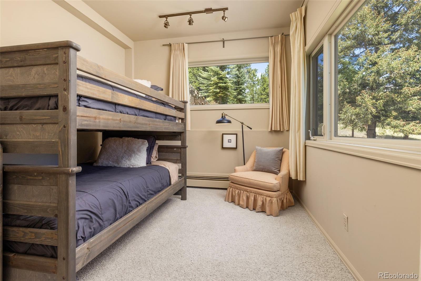 1323 South Snyder Gulch Road Evergreen, CO 80439 - Photo 38 of 47 a bedroom with a bed and a window