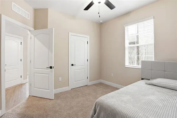 a bedroom with a bed and a window