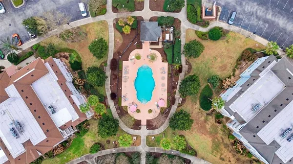 aerial view of a swimming pool with outdoor seating and yard