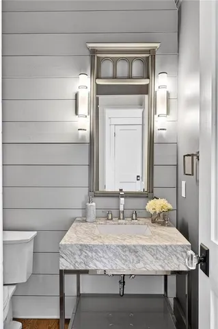 a living room with furniture a chandelier and a potted plant