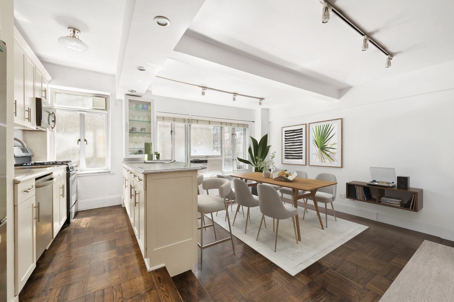 20 East 35th Street, Unit 2E Manhattan, NY 10035 - Photo 1 of 10 a dining room with kitchen island stainless steel appliances furniture and a dining table