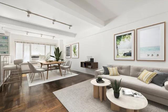 a dining room with furniture and a window