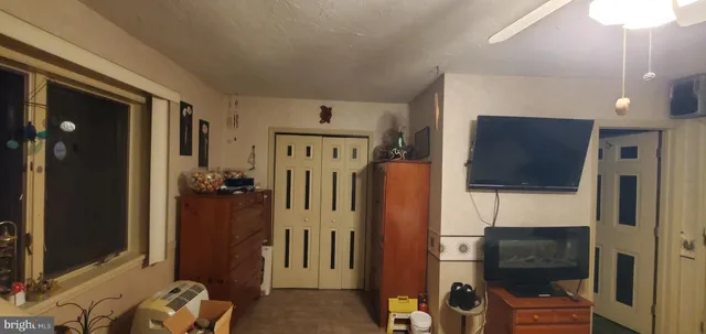 a bedroom with a bed and a flat screen tv