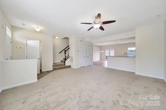 a view of a room with wooden floor and windows