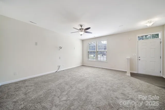wooden floor in an empty room with a ceiling fan