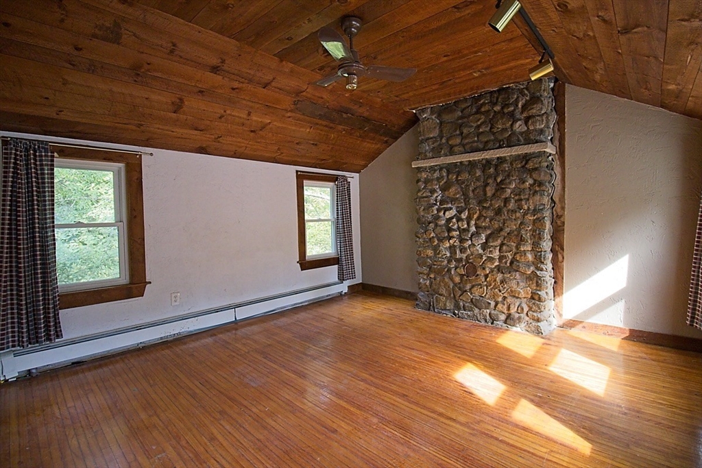 45 Depot Street, Unit 2 Sharon, MA 02067 - Photo 2 of 12 a view of an empty room with wooden floor and a window
