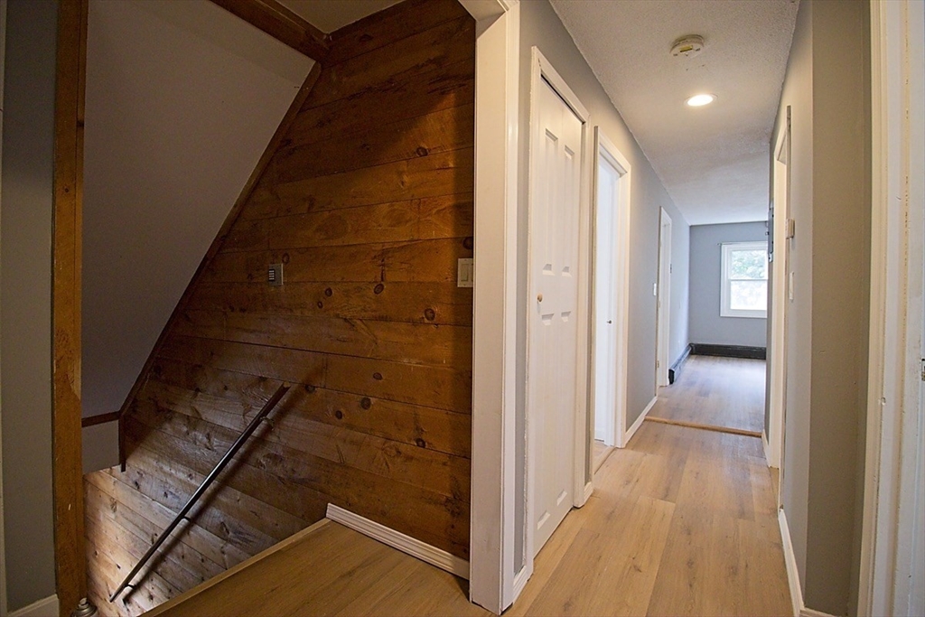 45 Depot Street, Unit 2 Sharon, MA 02067 - Photo 3 of 12 a view of a hallway with wooden floor and staircase