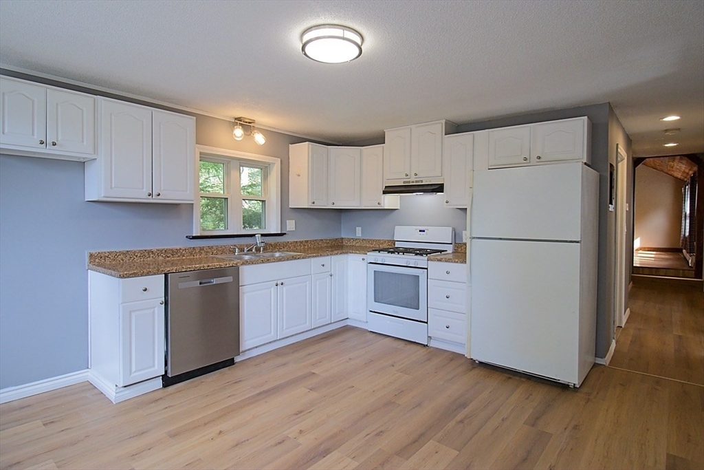 45 Depot Street, Unit 2 Sharon, MA 02067 - Photo 4 of 12 a kitchen with white cabinets white stainless steel appliances and sink