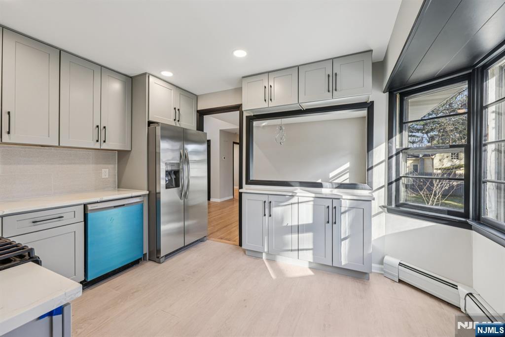 217 Knickerbocker Road Closter, NJ 07624 - Photo 11 of 27 a kitchen with stainless steel appliances granite countertop a refrigerator and a stove