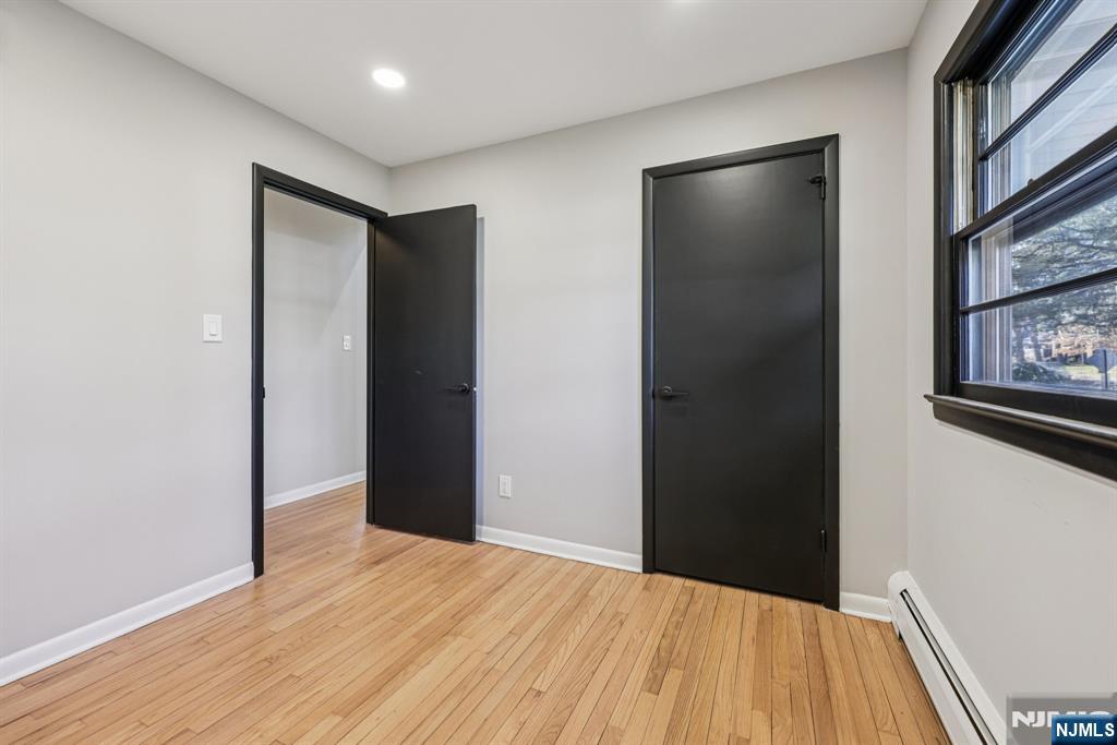217 Knickerbocker Road Closter, NJ 07624 - Photo 21 of 27 a view of an empty room with wooden floor and a window