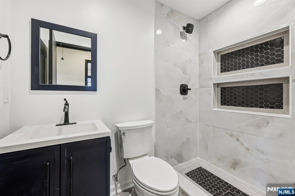 217 Knickerbocker Road Closter, NJ 07624 - Photo 22 of 27 a bathroom with a sink a toilet and shower