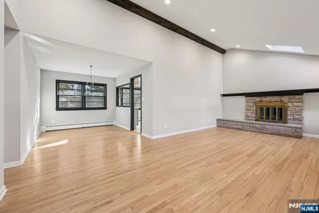 a view of an empty room window and wooden floor