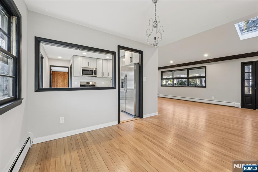 217 Knickerbocker Road Closter, NJ 07624 - Photo 8 of 27 a view of an empty room with a window and wooden floor