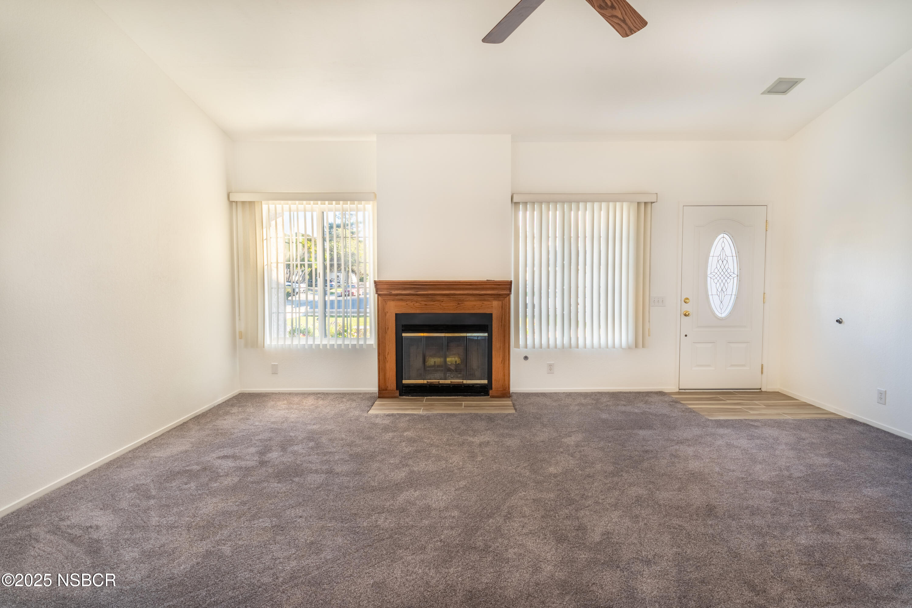901 Arnold Avenue Lompoc, CA 93436 - Photo 12 of 21 an empty room with windows and fireplace