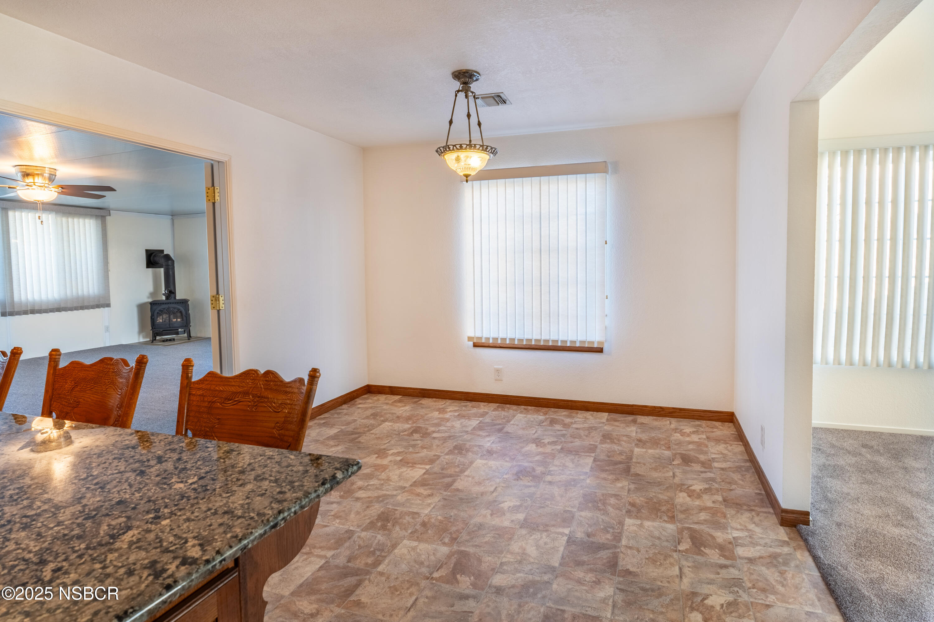 901 Arnold Avenue Lompoc, CA 93436 - Photo 10 of 21 a view of a bedroom with a bed and a chandelier