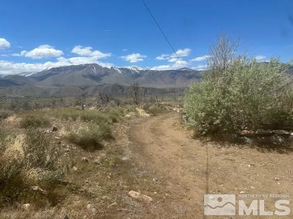 a view of a room with a chandelier fan and mountain view