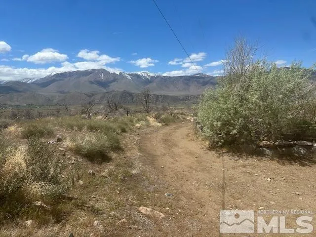 a view of a room with a chandelier fan and mountain view