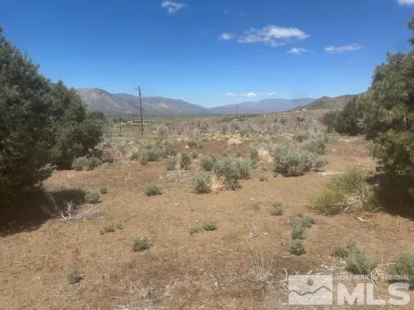 a view of mountain with sunset in background